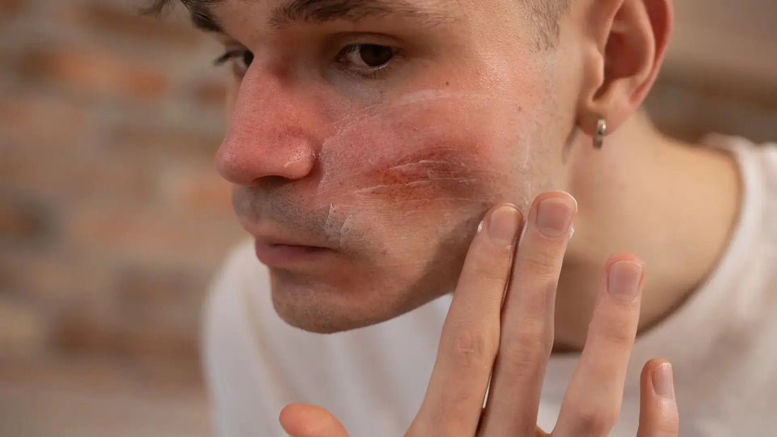 A stressed man looking in the mirror and touching his neck, frustrated by red bumps after shaving.