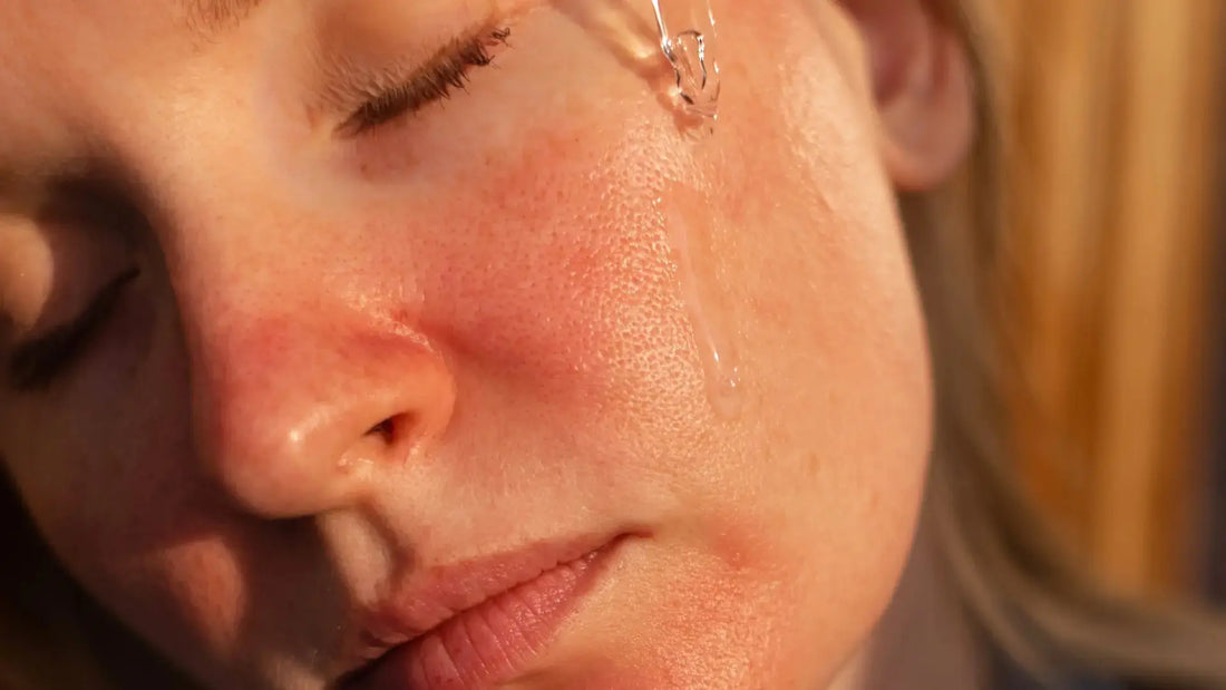 A stressed person looking in the mirror and touching their red, peeling skin, feeling frustrated by retinol burn.