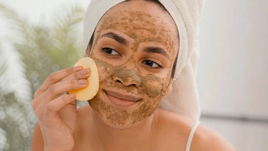 A person enjoying a skincare moment with a towel-wrapped head and a natural face mask